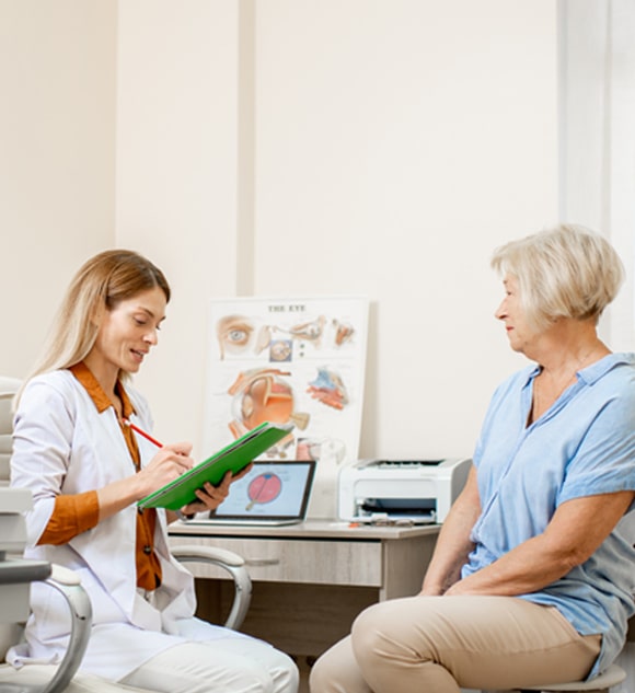 Doctor filling out form with patient. 