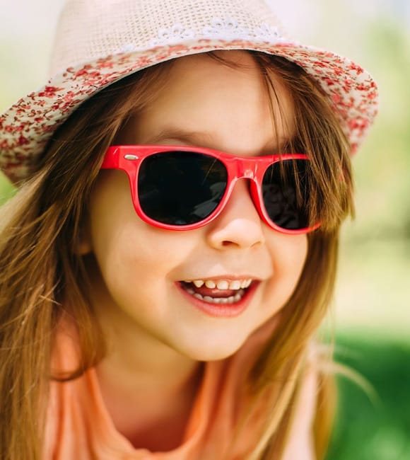 Child wearing sunglasses with scratch resistant coating