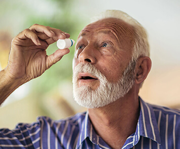 Man applying eye drops for dry eyes